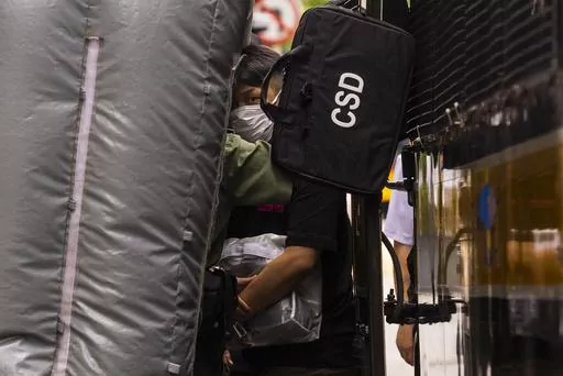 Detained activist Jimmy Sham, center, leaves a prison van to enter the Court of Final Appeal as Hong Kong's top court hear the activist's last bid to ask for recognition of his New York-registered same-sex marriage in Hong Kong, Wednesday, June 28, 2023. (AP Photo/Louise Delmotte)