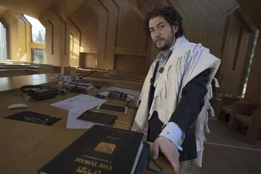 Rabbi Joshua Franklin stands inside the sanctuary at the Jewish Center of the Hamptons in East Hampton, New York on Feb. 10, 2023. Franklin expermented writing a sermon for his congregation using artificial intelligence software Chat GPT, and concluded that AI can't replace the work of human faith leaders. (AP Photo/Robert Bumsted)