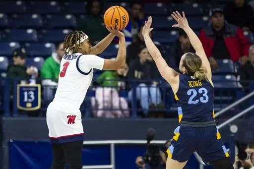 Mississippi guard Kennedy Todd-Williams (3) shoots as Marquette guard Jordan King (23) defends during the second half of a first-round college basketball game in the NCAA Tournament Saturday, March 23, 2024, in South Bend, Ind. (AP Photo/Michael Caterina)