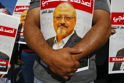 People hold posters of slain Saudi journalist Jamal Khashoggi, near the Saudi Arabia consulate in Istanbul, Oct. 2, 2020, marking the two-year anniversary of his death. In a surprise development, the prosecutor in the case against 26 Saudi nationals charged in the slaying of Washington Post columnist Jamal Khashoggi requested Thursday March 31, 2022, that their trail in absentia be suspended and the case be transferred to Saudi Arabia. (AP Photo/Emrah Gurel, File)