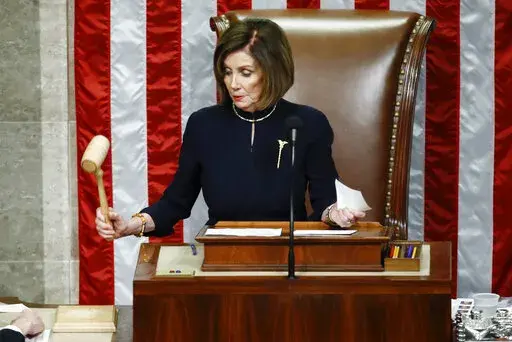 House Speaker Nancy Pelosi of Calif., strikes the gavel after announcing the passage of article II of impeachment against President Donald Trump, Dec. 18, 2019, on Capitol Hill in Washington. (AP Photo/Patrick Semansky, File)