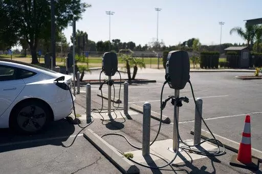 Electric vehicle chargers are seen in the parking lot of South El Monte High School in South El Monte, Calif., Friday, Aug. 26, 2022. Discounted prices, car-share programs, and a robust network of public charging stations are among the ways California will try to make electric vehicles affordable and convenient for people of all income levels as it phases out the sale of new gas cars by 2035. Advocates for the policy say the switch from gas- to battery-powered cars is a necessary step to reducin