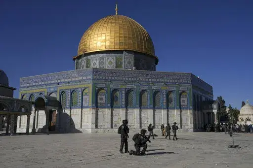 Israeli security forces take position during clashes with Palestinians demonstrators in front of the Dome of the Rock shrine at the Al Aqsa Mosque compound in Jerusalem's Old City, April 15, 2022. In the weeks before a rare confluence of major Jewish, Christian and Muslim holidays, with tens of thousands of visitors expected in Jerusalem for the first time since the pandemic, Israeli, Palestinian and Arab leaders discussed how to calm tensions. It hasn't worked out as planned. (AP Photo/Mahmoud 