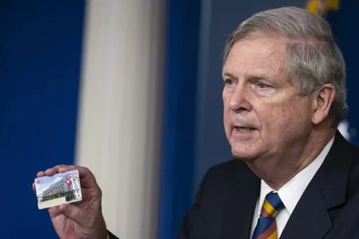 Agriculture Secretary Tom Vilsack holds up a Supplemental Nutrition Assistance Program Electronic Benefits Transfer (SNAP EBT) card during a news conference at the White House, Wednesday, May 5, 2021, in Washington. Nearly 21 million children in the U.S. and its territories are expected to receive food benefits this summer through a newly permanent federal program, the United States Department of Agriculture announced Wednesday, Jan. 10, 2024. “No child in this country should go hungry,” Vil