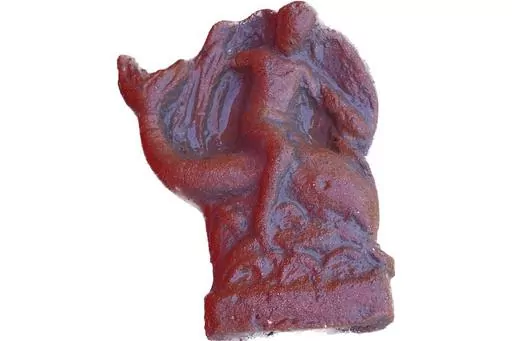 This undated photo shows a terracotta figurine of Eros riding a dolphin found in a newly discovered sanctuary, which dates from the 5th century B.C., that was first identified in 2019 along the ancient city walls of Paestum, Southern Italy. The excavations of the sanctuary in the ancient city of Paestum have unearthed seven terracotta bull heads and a figurine of Eros riding a dolphin that shines new light on the religious life and rituals of the ancient Greek city, culture ministry officials sa