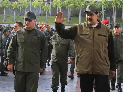 In this May 2, 2019 photo released by the Miraflores Press Office, Venezuela's President Nicolas Maduro, right, accompanied by his Defense Minister Vladimir Padrino, waves upon his arrival to Fort Tiuna, in Caracas, Venezuela. Venezuelan military officials said Saturday, Dec. 30, 2023, that they will continue to deploy nearly 6,000 troops until a British military vessel sent to neighboring Guyana leaves the waters off the coast of the two South American nations. (Jhonn Zerpa/Miraflores Press Off