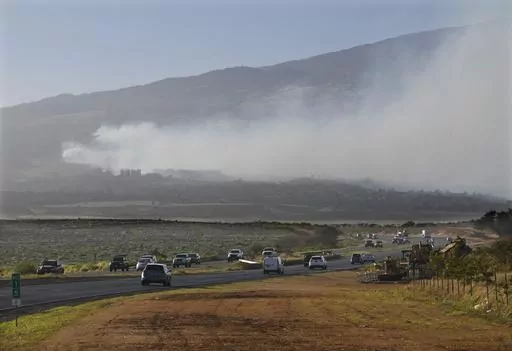 Smoke blows across the slope of Haleakala volcano on Maui, Hawaii, as a fire burns in Maui's upcountry region on Tuesday, Aug. 8. 2023. Several Hawaii communities were forced to evacuate from wildfires that destroyed at least two homes as of Tuesday as a dry season mixed with strong wind gusts made for dangerous fire conditions. (Matthew Thayer/The Maui News via AP)