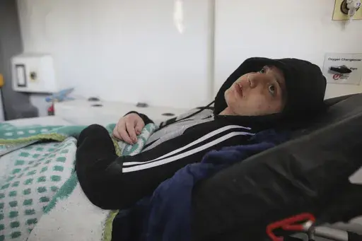 A Palestinian girl wounded in the Israeli bombardment of the Gaza Strip waits inside an ambulance before crossing the Rafah border into Egypt, as wounded and sick Palestinians are allowed to leave the Gaza Strip for medical treatment, in Khan Younis, Saturday Feb. 1, 2025. (AP Photo/Jehad Alshrafi)