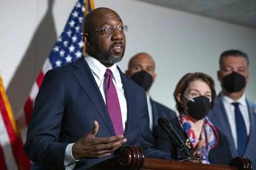 Sen. Raphael Warnock, D-Ga., speaks to reporters alongside Sen. Cory Booker, D-N.J., and Sen. Amy Klobuchar, D-Minn., and Sen. Alex Padilla, D-Calif., during a news conference at the Capitol in Washington, on Jan. 18, 2022. There's a shifting narrative on COVID-19 restrictions across the country among Democratic officials and candidates. They're increasingly supportive of easing mandates as they struggle to address voter frustration with the lingering pandemic. (AP Photo/Amanda Andrade-Rhoades, 