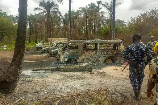 People gather Saturday April 23, 2022 at the site of an explosion that took place the day before at an illegal oil refinery in Ohaji-Egbema local government area in Imo state, southeast Nigeria. At least 100 people are feared to have died in the explosion, authorities told The Associated Press, as the search for bodies at the site and for two people suspected of being involved in the incident intensified. (AP Photo)