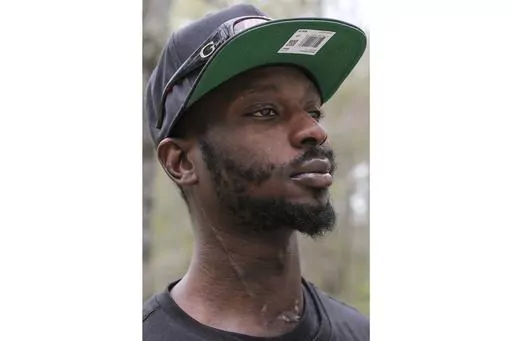 Michael Corey Jenkins stands outside Taylor Hill Church in Braxton, Miss., March 18, 2023. An off-duty police officer participated in a raid where two Black men — Jenkins and his friend Eddie Terrell Parker — say deputies beat and sexually assaulted them before shooting Jenkins in the mouth, a Mississippi police chief said Monday, July 3. (AP Photo/HG Biggs, File)