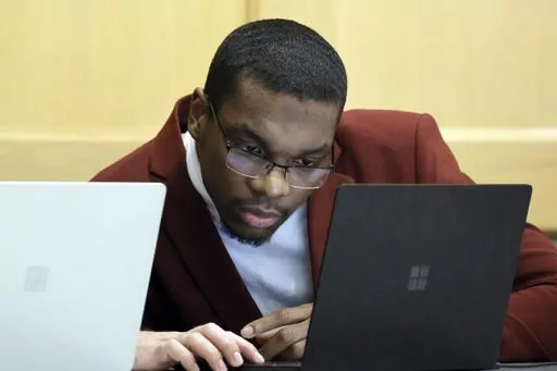 Shooting suspect Michael Boatwright looks at his attorney's computer at the defense table on the fourth day of jury deliberations in the XXXTentacion murder trial at the Broward County Courthouse in Fort Lauderdale, Fla., Monday, March 13, 2023. Emerging rapper XXXTentacion, born Jahseh Onfroy, 20, was killed during a robbery outside of Riva Motorsports in Pompano Beach in 2018, allegedly by defendants Boatwright, Trayvon Newsome, and Dedrick Williams. (Amy Beth Bennett/South Florida Sun-Sentine