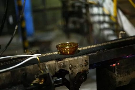 A bowl is manufactured in the factory of the French glassmaker Duralex, in La Chapelle Saint-Mesmin, central France, Wednesday, Sept. 7, 2022. Iconic French tableware brand Duralex is joining a growing array of European firms that are reducing and halting production because of soaring energy costs. (AP Photo/Thibault Camus)
