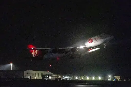 A repurposed Virgin Atlantic Boeing 747 aircraft, named Cosmic Girl, carrying Virgin Orbit's LauncherOne rocket, takes off from Spaceport Cornwall at Cornwall Airport, Newquay, England, Monday, Jan. 9, 2023. The plane will carry the rocket to 35,000 feet where it will be released over the Atlantic Ocean to the south of Ireland, as part of the Start Me Up mission and the first rocket launch from U.K. The rocket will take multiple small satellites, with a variety of civil and defence applications,