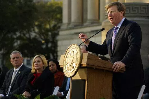 Mississippi Gov. Tate Reeves says during his State of the State speech on Jan. 25, 2022, at the state Capitol that he supports a proposal to phase out the state income tax. House Speaker Philip Gunn, right, and the governor’s wife, Elee Reeves, listen to the speech. (AP Photo/Rogelio V. Solis, File)