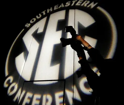 A photographer takes a photo at the Southeastern Conference NCAA college football media days, in Hoover, Ala., July 15, 2014. (AP Photo/Butch Dill, File)