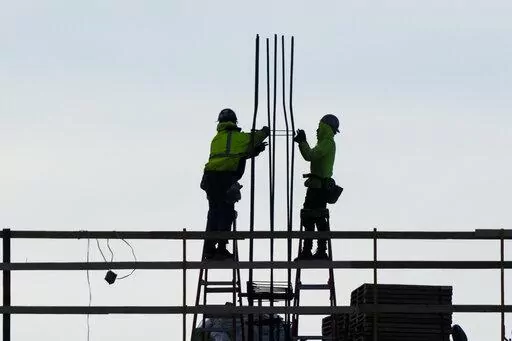 Construction workers work on a building in Philadelphia, Wednesday, Dec. 21, 2022. America’s employers added a solid 223,000 jobs in December, evidence that the economy remains healthy yet also a sign that the Federal Reserve may still have to raise interest rates aggressively to slow growth and cool inflation. (AP Photo/Matt Rourke, File)