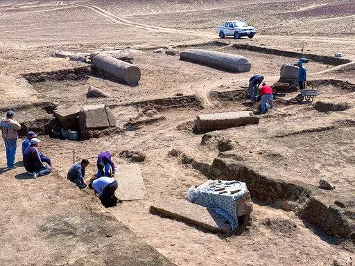 This undated photo provided by the Egyptian Tourism and Antiquities Ministry on Monday, April 25, 2022, shows archeologists working in the ruins of a temple for Zeus-Kasios, the ancient Greek god, at the Tell el-Farma archaeological site in the northwestern corner of the Sinai Peninsula. Tell el-Farma, also known by its ancient name Pelusium, dates back to the late Pharaonic period and was also used during Greco-Roman and Byzantine times. (Egyptian Tourism and Antiquities Ministry via AP)