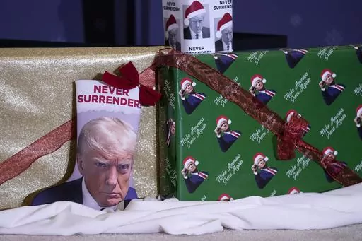 Christmas gifts are seen on the stage during a former President Donald Trump commit to caucus rally, Tuesday, Dec. 19, 2023, in Waterloo, Iowa. The field of 2024 presidential candidates may have some options for shoppers scrambling for a last-minute holiday gift. As the campaign for the White House kicks into full gear, the contenders are offering an onslaught of holiday-themed merchandise, many of which capture some of the surreal aspects of the 2024 race. (AP Photo/Charlie Neibergall, File)
