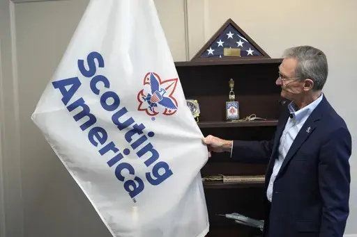 Roger Krone, chief executive officer of Scouting America, describes the design of the organization's flag in Irving, Texas, Wednesday, Feb. 5, 2025. (AP Photo/LM Otero)