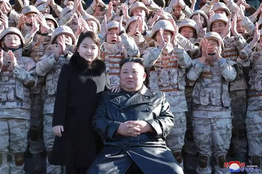 This undated photo provided on Nov. 27, 2022, by the North Korean government shows North Korean leader Kim Jong Un, center right, and his daughter, center left, with soldiers, pose for a photo,  following the launch of what it says a Hwasong-17 intercontinental ballistic missile, at an unidentified location in North Korea. Independent journalists were not given access to cover the event depicted in this image distributed by the North Korean government. The content of this image is as provided an
