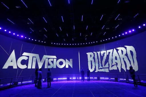 The Activision Blizzard Booth is shown on June 13, 2013 the during the Electronic Entertainment Expo in Los Angeles. Microsoft is buying Activision Blizzard, Tuesday, Jan. 18, 2022,  for $68.7 billion to gain access to blockbuster games including Call of Duty and Candy Crush. The all-cash deal will let Microsoft accelerate mobile gaming and provide it building blocks for the metaverse, or a virtual environment.  (AP Photo/Jae C. Hong, File)