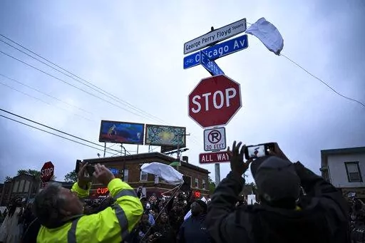 A new George Perry Floyd Square sign is unveiled in front of hundreds of community members Wednesday, May 25, 2022, in Minneapolis. The intersection where Floyd died at the hands of Minneapolis police officers was renamed in his honor Wednesday, among a series of events to remember a man whose killing forced America to confront racial injustice. (Aaron Lavinsky/Star Tribune via AP)