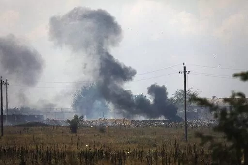 Smoke rises over the site of explosion at an ammunition storage of Russian army near the village of Mayskoye, Crimea, Tuesday, Aug. 16, 2022. Explosions and fires ripped through an ammunition depot in Russian-occupied Crimea on Tuesday in the second suspected Ukrainian attack on the peninsula in just over a week, forcing the evacuation of more than 3,000 people. (AP Photo)
