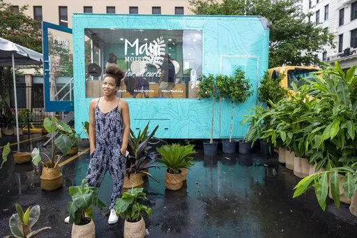 Vanessa Dawson, back left, producer of Maui Moisture, stands in her hair care truck near the Essence Festival in downtown New Orleans on Thursday, June 30, 2022. Essence's chief executive officer said she's been asked a multitude of times whether the Essence Festival of Culture is staying in New Orleans. On Thursday, Caroline Wanga ended any speculation, making the answer to that question very clear.(Chris Granger/The Times-Picayune/The New Orleans Advocate via AP)