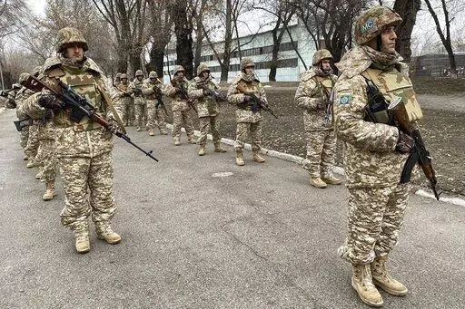 In this photo released by the Russian Defense Ministry Press Service, Collective Security Treaty Organization peacekeepers prepare to guard an area in Almaty, Kazakhstan, Tuesday, Jan. 11, 2022. The president of Kazakhstan has announced that a Russia-led security alliance will start pulling out its troops from the Central Asian country in two days after completing its mission. The mostly Russian troops were deployed to Kazakhstan last week by the Collective Security Treaty Organization, an allia