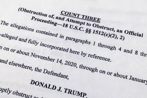 The indictment against former President Donald Trump charging him by the Justice Department for his efforts to overturn the results of the 2020 presidential election is photographed Tuesday, Aug. 1, 2023, in Washington. (AP Photo/Jon Elswick)