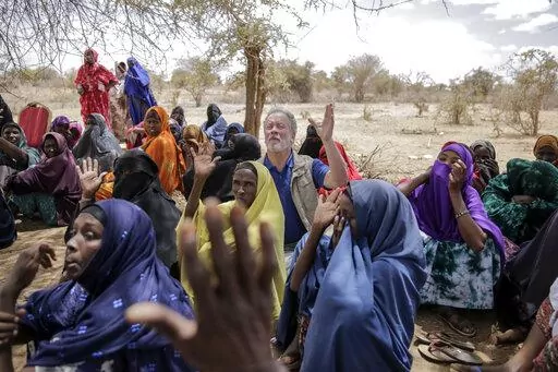 World Food Program chief David Beasley meets with villagers in the village of Wagalla in northern Kenya Friday, Aug. 19, 2022. The United States is stepping up to buy about 150,000 metric tons of grain from Ukraine in the next few weeks for an upcoming shipment of food aid from ports no longer blockaded by war, the World Food Program chief has told The Associated Press. (AP Photo/Brian Inganga)
