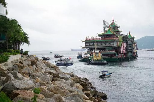 Hong Kong's iconic Jumbo Floating Restaurant is towed away in Hong Kong on June 14, 2022. The restaurant has capsized in the South China Sea less than a week after it was towed away from the city, its parent company said Monday, June 20, 2022. (AP Photo/Kin Cheung, File)