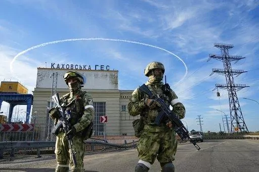 Russian troops guard an entrance of the Kakhovka Hydroelectric Station, a run-of-the-river power plant on the Dnieper River in Kherson region, southern Ukraine, May 20, 2022. The Kherson region has been under control of the Russian forces since the early days of the Russian military action in Ukraine. Russia and Ukraine have trade blame over shelling of the Zaporizhzhia nuclear power plant, Europe's largest.This photo was taken during a trip organized by the Russian Ministry of Defense. (AP Phot