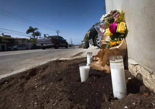 Candles and flowers are placed along along the Pacific Coast Highway, after a crash that killed four college students and injured two others, in Malibu, Calif., on Oct. 19, 2023. The 22-year-old driver of the BMW that struck and killed the four Pepperdine University students last week pleaded not guilty, Wednesday, Oct. 25, 2023, to four counts of murder, and prosecutors said he was speeding at more than 100 mph moments before the crash. (AP Photo/Richard Vogel, File)