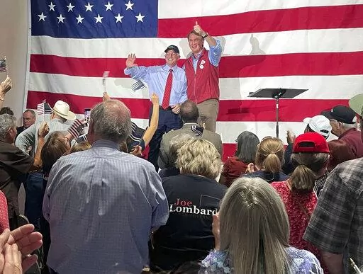 Virginia Gov. Glenn Youngkin, center right, gives a thumbs-up at an event in support of Nevada Republican gubernatorial nominee Joe Lombardo, center left, at the Nevada Trucking Association in Reno, Nev., Thursday, Sept. 15, 2022. (AP Photo/Gabe Stern)