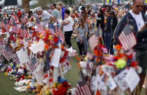 People visit a makeshift memorial honoring the victims of the Oct. 1, 2017, mass shooting in Las Vegas, on Nov. 12, 2017. Five years after a gunman killed 58 people and wounded hundreds more at a country music festival in Las Vegas, in the deadliest mass shooting in modern U.S. history, the massacre is now part of a horrifying increase in the number of mass slayings with more than 20 victims, according to a database of mass killings maintained by The Associated Press, USA Today and Northeastern 