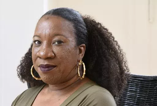 Tarana Burke, founder and leader of the #MeToo movement, sits in her home in Baltimore on Tuesday, Oct. 13, 2020. (AP Photo/Steve Ruark, File)