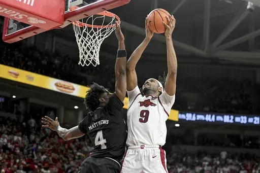 Arkansas forward Jonas Aidoo (9) shoots over Mississippi State forward Cameron Matthews (4) during the second half of an NCAA college basketball game Saturday, March 8, 2025, in Fayetteville, Ark. (AP Photo/Michael Woods)