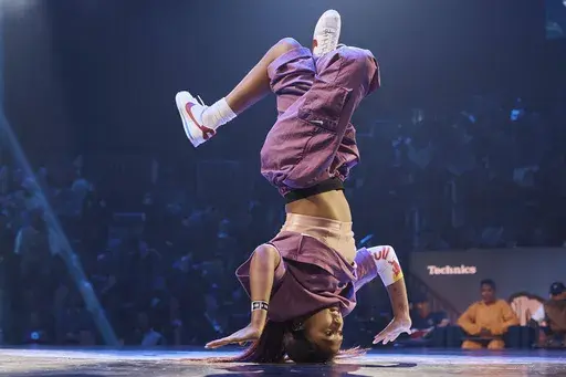 Logan Edra, also known as B-Girl Logistx, of the United States competes in the B-girl Red Bull BC One World Final at Hammerstein Ballroom on Saturday, Nov. 12, 2022, in New York. (AP Photo/Andres Kudacki, File)