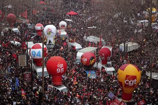 People gather on Place de la Republique during a demonstration against proposed pension changes, Thursday, Jan. 19, 2023 in Paris. Workers in many French cities took to the streets Thursday to reject proposed pension changes that would push back the retirement age, amid a day of nationwide strikes and protests seen as a major test for Emmanuel Macron and his presidency. (AP Photo/Lewis Joly)