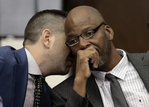 Christopher Dunn, right, listens to his attorney Justin Bonus from New York City during the first day of his hearing to decide whether to vacate his murder conviction, Tuesday, May 21, 2024, at the Carnahan Courthouse in St. Louis. A Missouri judge on Monday, July 24, 2024, overturned the conviction of Dunn, who has spent more than 30 years in prison for a killing he has long contended he didn’t commit. (Laurie Skrivan/St. Louis Post-Dispatch via AP, Pool, File)