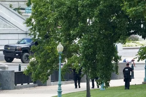 A man is apprehended after being in a pickup truck parked on the sidewalk in front of the Library of Congress' Thomas Jefferson Building, as seen from a window of the U.S. Capitol, Aug. 19, 2021, in Washington. A man who caused evacuations and an hourslong standoff with police on Capitol Hill when he claimed he had a bomb in his pickup truck outside the Library of Congress pleaded guilty on Friday, Jan. 27, 2023, to a charge of threatening to use an explosive. Floyd Ray Roseberry faces up to 10 