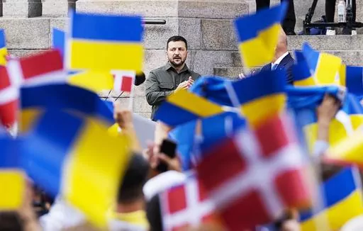 Ukrainian President Volodymyr Zelenskyy addresses the Danish people from the steps of Christiansborg palace, the seat of Danish Parliament, in Copenhagen, Denmark, Monday, Aug. 21, 2023. Thousands of people had gathered in the palace courtyard to hear his speech, many waving Ukrainian or Danish flags. (Claus Bech/Ritzau Scanpix via AP)