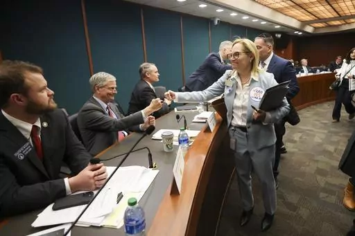 Rep. Esther Panitch, D-Sandy Springs, right, fist bumps Sen. Ben Watson, R-Savannah, a member of the Senate Judiciary Committee, after House Bill 30, an antisemitism bill, was passed unanimously by the Senate Judiciary Committee in the Coverdell Legislative Office Building, Jan. 22, 2024, in Atlanta. A handful of U.S. states are considering measures that would define antisemitism, but there's debate over whether they would stifle criticism of Israel. (Jason Getz/Atlanta Journal-Constitution via 