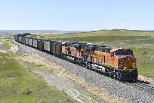A BNSF railroad train hauling carloads of coal from the Powder River Basin of Montana and Wyoming is seen east of Hardin, Mont., on July 15, 2020. Business and top officials are bracing for the possibility of a nationwide rail strike on Friday, Sept. 16, 2022, while talks continue between the nation's largest freight railroads and their unions. (AP Photo/Matthew Brown, File)