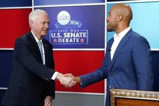 U.S. Sen. Ron Johnson, R-Wis., left, and his Democratic challenger Mandela Barnes shake hands before a televised debate, Friday, Oct. 7, 2022, in Milwaukee. (AP Photo/Morry Gash)
