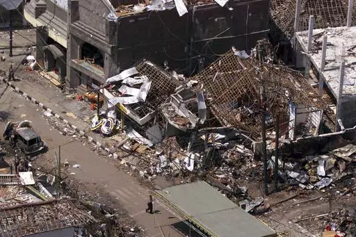 The wreckage of the Sari night club and surrounding buildings are seen in this aerial view Oct. 15, 2002 in Kuta, Bali. Relatives of some of the more than 200 people killed in 2002 bombings on the resort island of Bali are testifying at a sentencing hearing at Guantanamo Bay in Cuba. Two Malaysian men, both longtime detainees at Guantanamo, have pleaded guilty in connection with the bombing. (AP Photo/Achmad Ibrahim, File)
