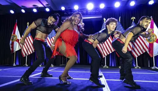 Drag performer Velvet LeNore joins dancers on stage during the gala at the Florida Democratic Party's Annual Leadership Blue Weekend at the Fontainebleau Hotel on Miami Beach, Fla., Saturday, July 8, 2023. (Al Diaz/Miami Herald via AP)