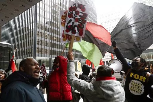 Protesters call for federal civil rights charges during a rally after former Chicago police officer Jason Van Dyke was released from prison  Thursday, Feb. 3, 2022 at Federal Plaza in Chicago. Former Chicago police Officer Jason Van Dyke left prison on Thursday after serving less than half of his nearly seven-year sentence for killing Black teenager Laquan McDonald, angering community leaders who feel the white officer's punishment didn't fit his crime.. (John J. Kim/Chicago Tribune via AP)